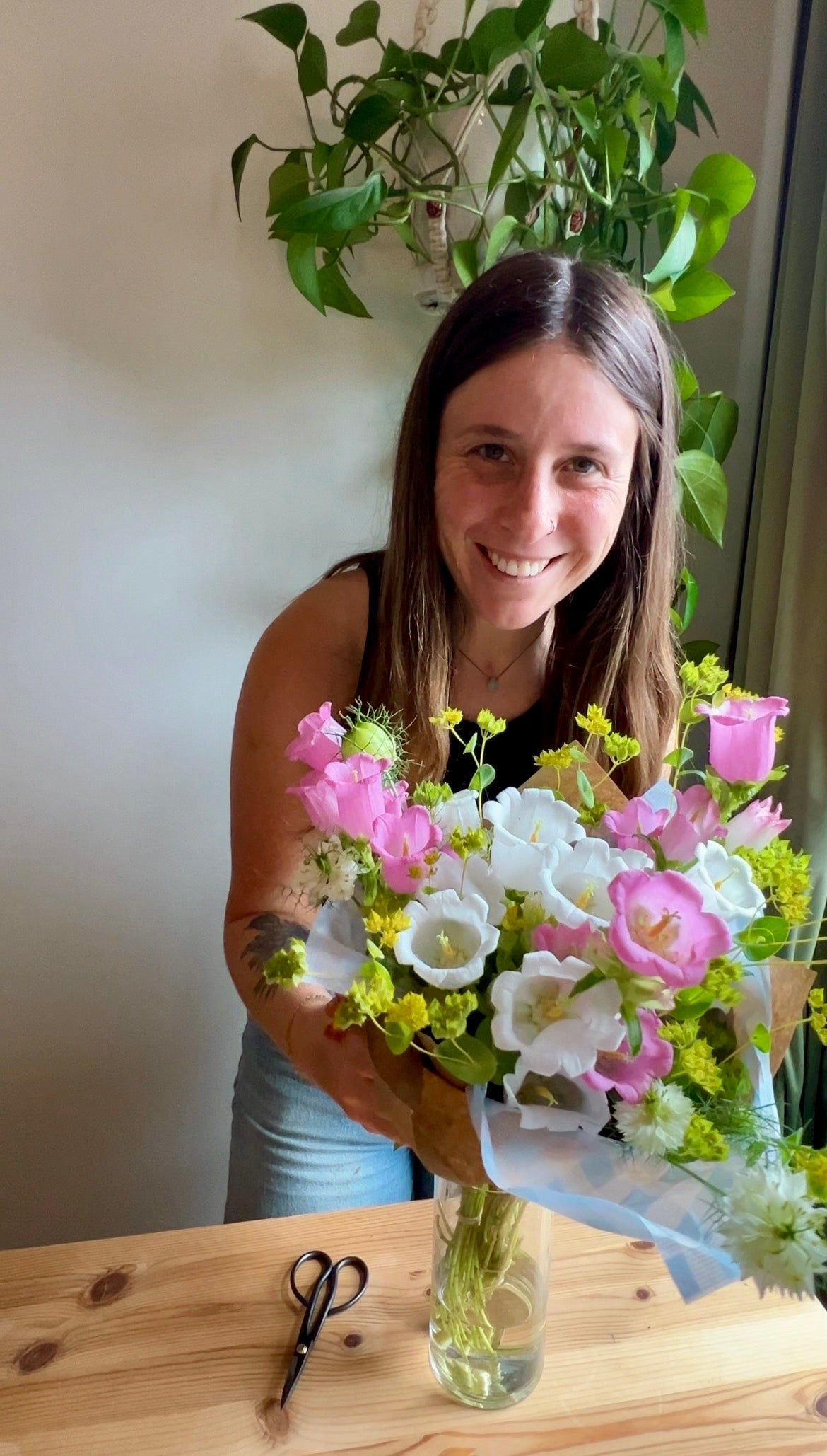 Hope smiling with a bouquet of fresh flowers.