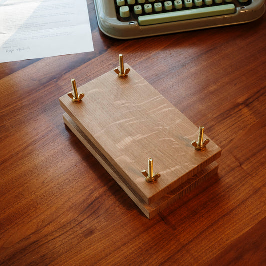Hardwood Flower press with brass bolts on a desk.