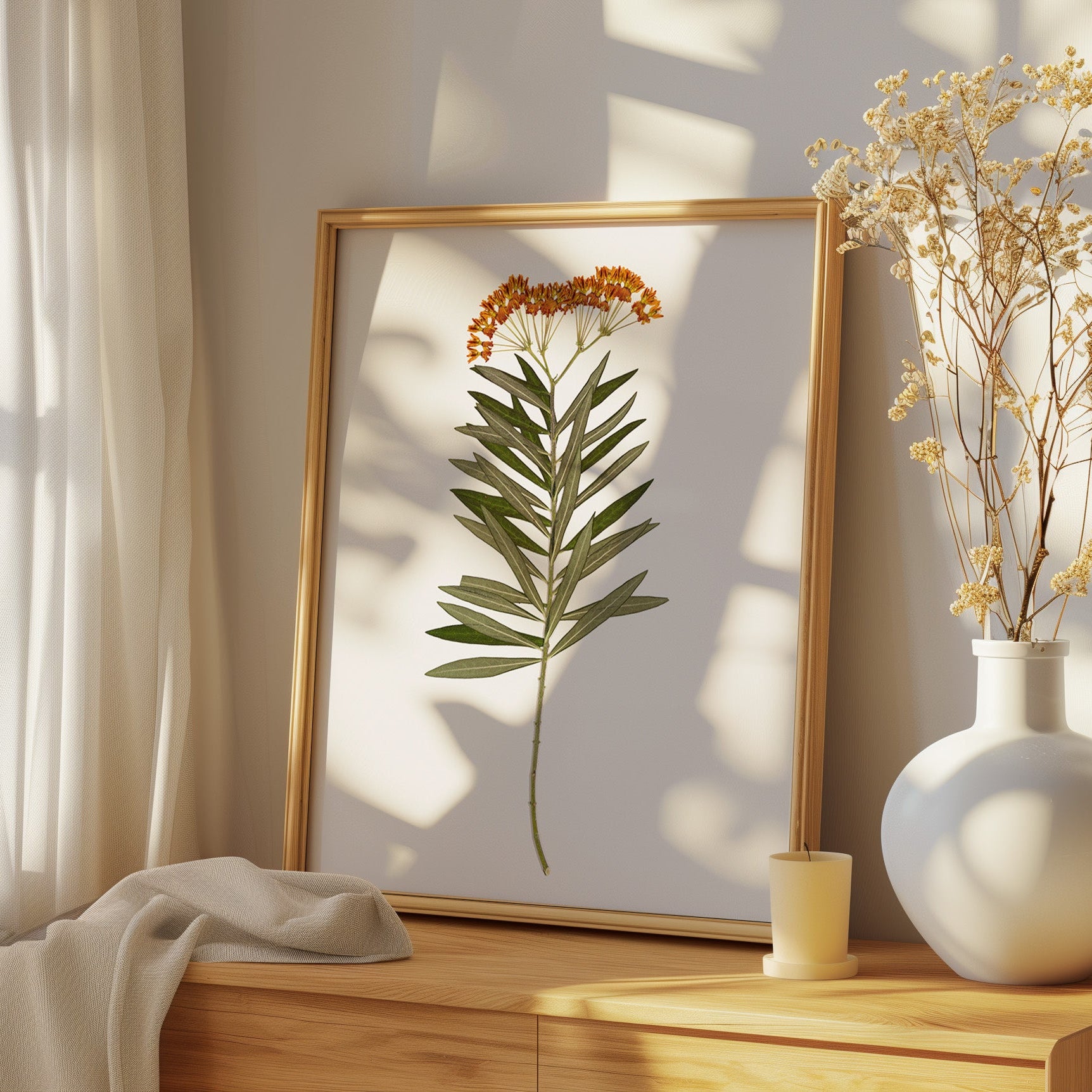 pressed milkweed art print on dresser in bedroom.