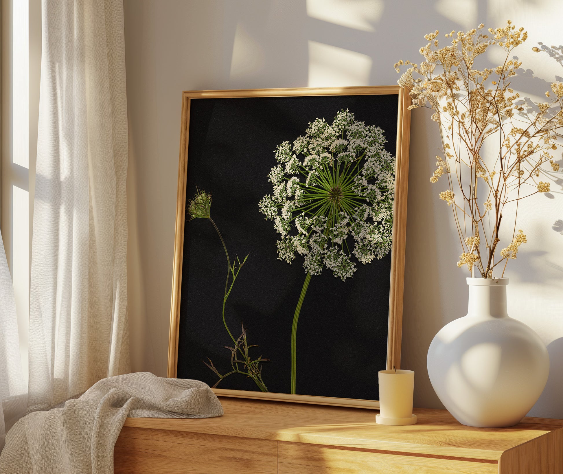 Framed fine art print of queen anne's lace on a bedroom dresser.