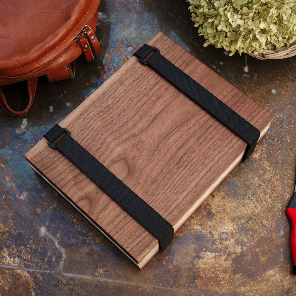 The Wildwood Travel Flower Press Walnut Wood with black velcro straps.